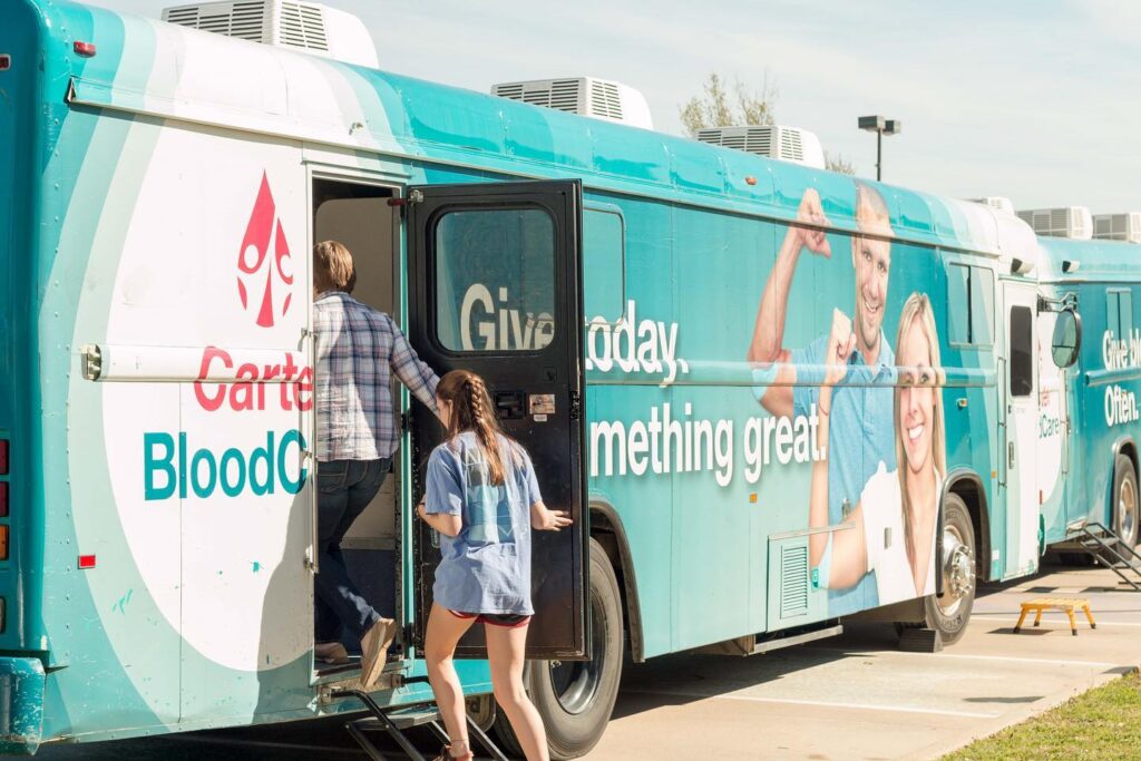 Blood donation bus photo with donors entering